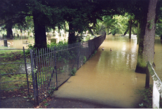 Bottesford flood, 2001 In AUgust 2001 after a day of record rainfall the river burst its banks and flooded part of the churchyard, as well as much of the rest of the centre of the village. This picture was taken from Fleming's Bridge looking along the riverbank path. | Neil Fortey, August 2001