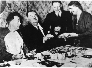 Stan Laure; (left) and Oliver Hardy dining at the Bull, with Olga Healey and her husband - she was Stan's sister. Oliver & Hardy, the American movie comedians, were touring England in 1953. | Picture contributed by Mr John Cooper
