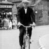 Mr Slater cycling past Standley's store