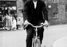 Mr Slater cycling past Standley's store