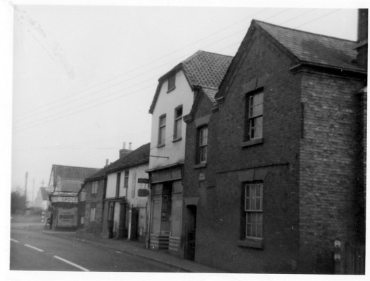 The row of old shops on the High Street, all demolished except for the far end