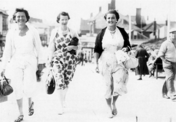 Three ladies strolling probably along the front in Skegness