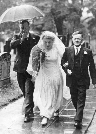 Wedding picture, Betty Robinson being given away by her father Tommy Robinson, walking along the path to the porch of St Mary's. | Bottesford Heritage Archive