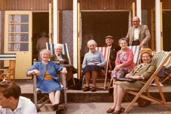 colour picture of elderly group in deckchairs at seaside