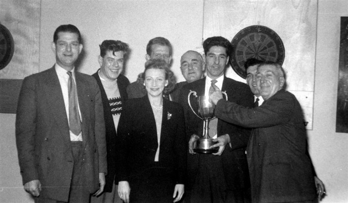 darts team posing with trophy
