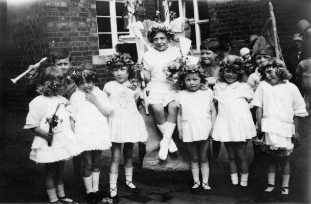 infant girls with May Queen in school yard