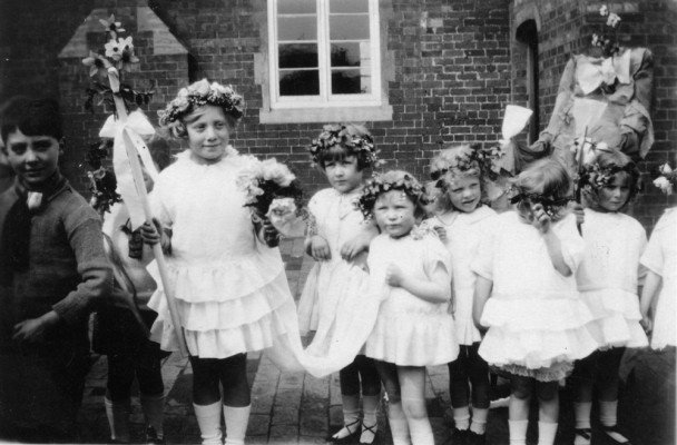infants parade with May Queen in school yard