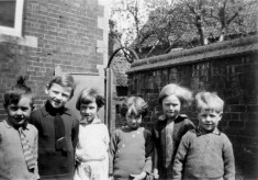 group of six children in a yard