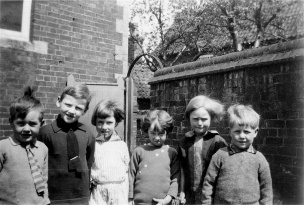 group of six children in a yard