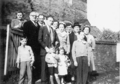 Family group outside cottage, location Muston, possibly the Webb family