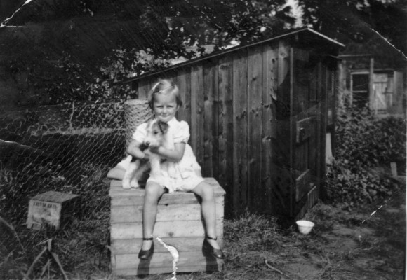 Gina Topps and pet terrier in a garden