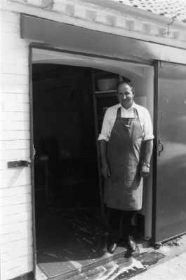 Butcher in front of shop