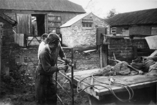 Trainee hands fixing a farm gate at Church Farm