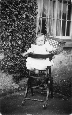 A baby in her high chair at The Elms