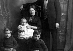 Grandad and Grandma Sellers, dad (Frank) on knee, Fred and Harry