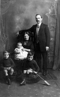Grandad and Grandma Sellers, dad (Frank) on knee, Fred and Harry