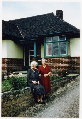 Elderly ladies by bungalow