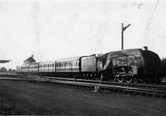 Express locomotive pulling a train through Bottesford Station