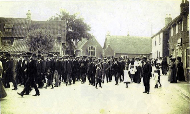 Bottesford Friendly Society members marching along Church Street, en route to St Mary's church for the inauguration of Edward Prince of Wales, 13th July 1911