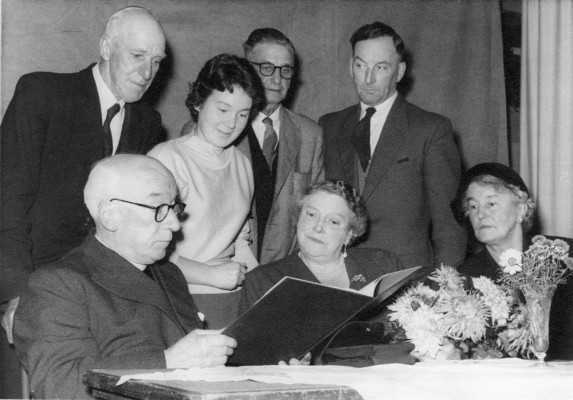Canon Blackmore, reading book, with others