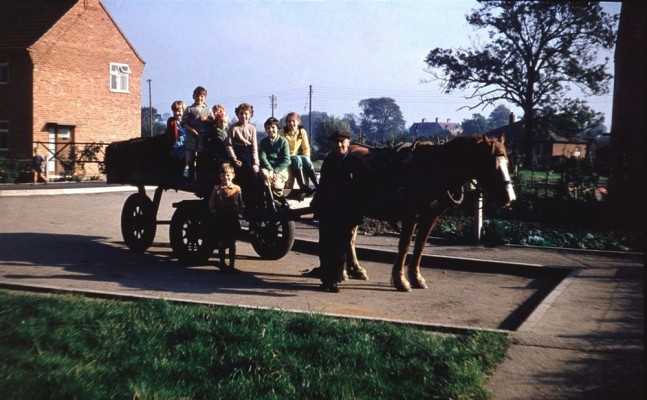 Children riding on Guy Lovett's coal wagon at South Crescent
