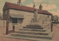 The Cross and Stocks, with Taylor's and Sutton's shops behind
