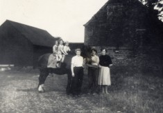 Calcraft family by the barns at Sykes Lane Farm, Muston