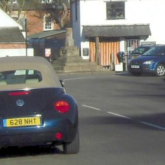 The road bends sharply to the right at the cross