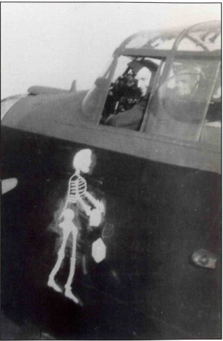 063_Ch_9_photo_843 F/Sgt Brian Howie RAAF sits in the cockpit of his usual aircraft, 'AApple' ED541. Already operational on 50 Squadron, it was hoped that the macabre artwork would bring the crew good luck on their posting to 467: they completed their tour on 9th March 1943 - the first to do so | ©️Vincent Holyoak