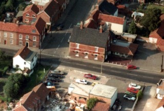 Aerial_NichollsSt Late 1970s aerial view of Ted's Garage and No. 11 High Street . The barn to the rear is under conversion