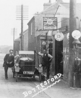 Christmas & Chorlton's Garage, Bottesford High Street: Billy is peering out from inside the garage door.