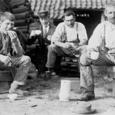 Three generations of brick makers sharing tea break, along with a fourth man in the uniform of a railway employee | From the collection of Mrs Jean Round
