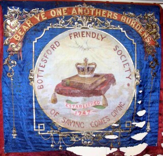 Bottesford Friendly Society banner showing damage to the fabric Bottesford Friendly Society banner showing damage to the fabric