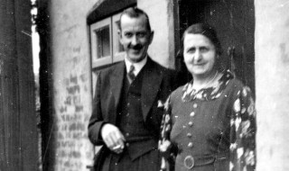 Mr. and Mrs. Taplin outside their cottage on Queen Street.