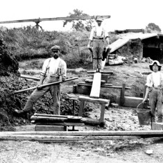 Picture 1 shows the shaft of the pugmill behind the three brickyard workers pausing in their work to pose for the camera.