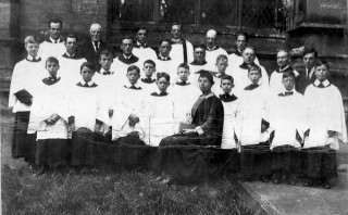 Bottesford St Mary's choir and choir mistress Miss Beatrice James outside the chancel of St Mary's