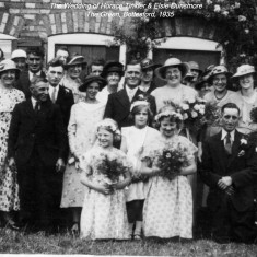 Dunsmore_Wedding_crop The Wedding of Horace Tinkler and Elsie Dunsmore, The Green, 1935. Kneeling front right: Connie and Arthur Guy. End of 2nd row, left: Mr. Skinner. End of 4th row, left: Thomas Waudby. Just visible at the very back in front of the window: Henry and Frank Dunsmore. Next to the Groom, left: Annie Dunsmore (nee Ricketts). Back row, visible between the Groom and Bride: Louisa Ann Dunsmore (nee Bellamy). Back row, third from right, in white hat: Betty Whatton (nee Waudby). Between the two bridesmaids, centre: Margaret Waudby, aged 8. We can add, thanks to Jean Rigby, that the gentleman second from left in the third row is Martin Killeen, and the lady to his left, wearing a hat with a diagonal ribbon, is his wife Mabel (nee Tinkler).