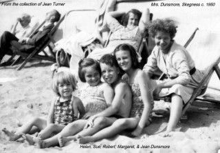 The Dunsmore Family at Skegness, c.1956, sitting on the beach on a sunny day at Skegness, Lincolnshire | Sue Dunsmore