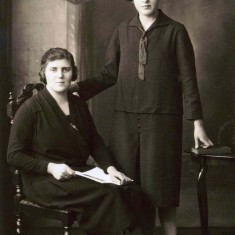 Mary at the age of sixteen standing with her sister Margaret in their travelling clothes before their journey in 1926 from Crossmichael to Muston