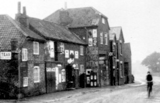 High Street Shops c. 1930. In the 1880s the Post Office was one of these shops.
