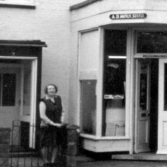 Mrs. Moulsher outside Moulsher's Shop