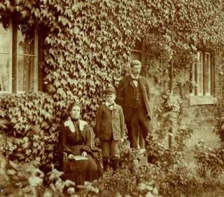Mr_Collett Mr Victor Collett and family in front of the School House