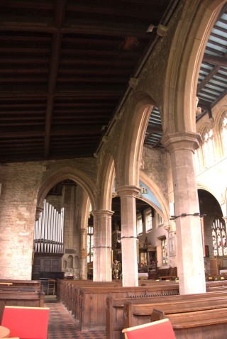 A view of the north aisle looking eastwards, showing the arch which crosses the eastern end of the aisle.