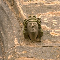 Carved face on window moulding on the south face of the tower.