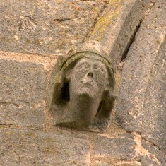 Carved face on window moulding on the south face of the tower.