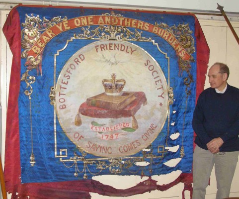 Mike Saunders unveils the Bottesford Friendly Society's marching banner | Bottesford Local History Society