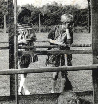 A close-up of two of the children admiring the peacocks.
