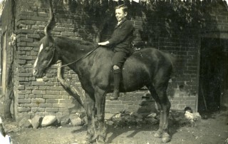 Photos056 Tom Samuel on a pony by the barns at the back of the Market Street Store