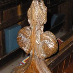 A carved pew end in Muston church.