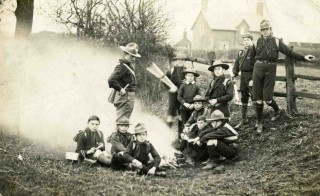 Scouts Camp Fire 1912 Bottesford Scouts camp fire c 1912. Standing left - Charles Calcraft; seated left of fire, L to R - unknown, Sydney Taylor, Arthur Taylor; standing right of fire L to R - Edgar Culpin?, Bill Cooper, Wilf/Harry? Challands; seated right of fire, L to R - Bob Sutton, Frank Sutton?, unknown; standing rear by fence: unknown, Harry Lane.